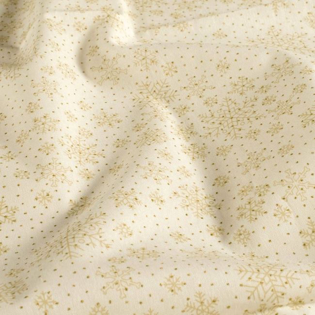 Christmas fabric made of cotton in cream color with a print of golden snowflakes 60554/051
