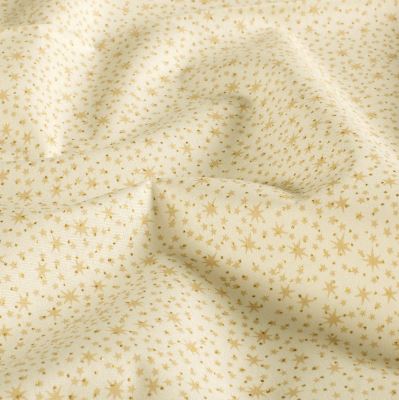 Christmas fabric made of cotton in cream color with a print of small gold stars 60550/051 Christmas fabric made of cotton in cream color with a print of small gold stars 60550/051