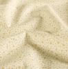 Christmas fabric made of cotton in cream color with a print of small gold stars 60550/051