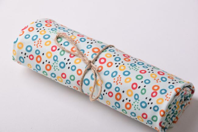 Roll of cotton knit in mint color with wheel print RO19587/021