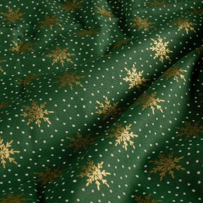 Christmas cotton fabric in green with a print of golden snowflakes 60679/025 Christmas cotton fabric in green with a print of golden snowflakes 60679/025