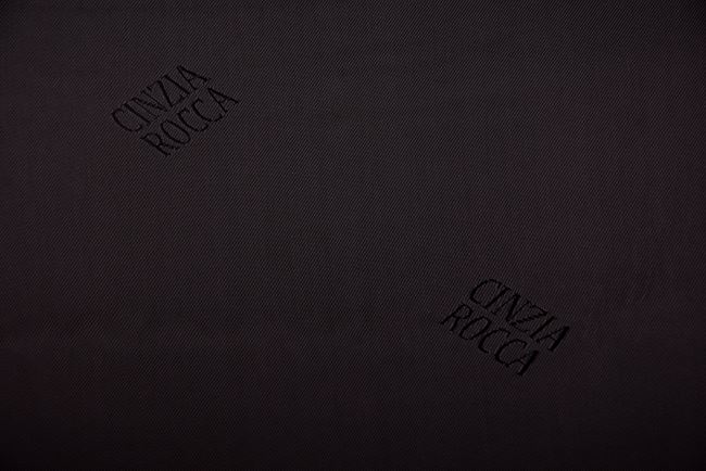 Polyester lining in black with a woven pattern of the inscription PO26
